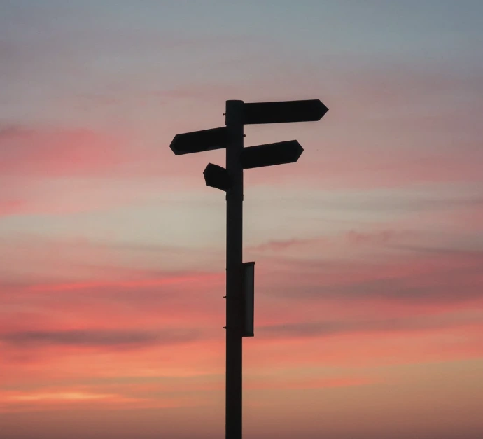 silhouette of a road signage during golden hour